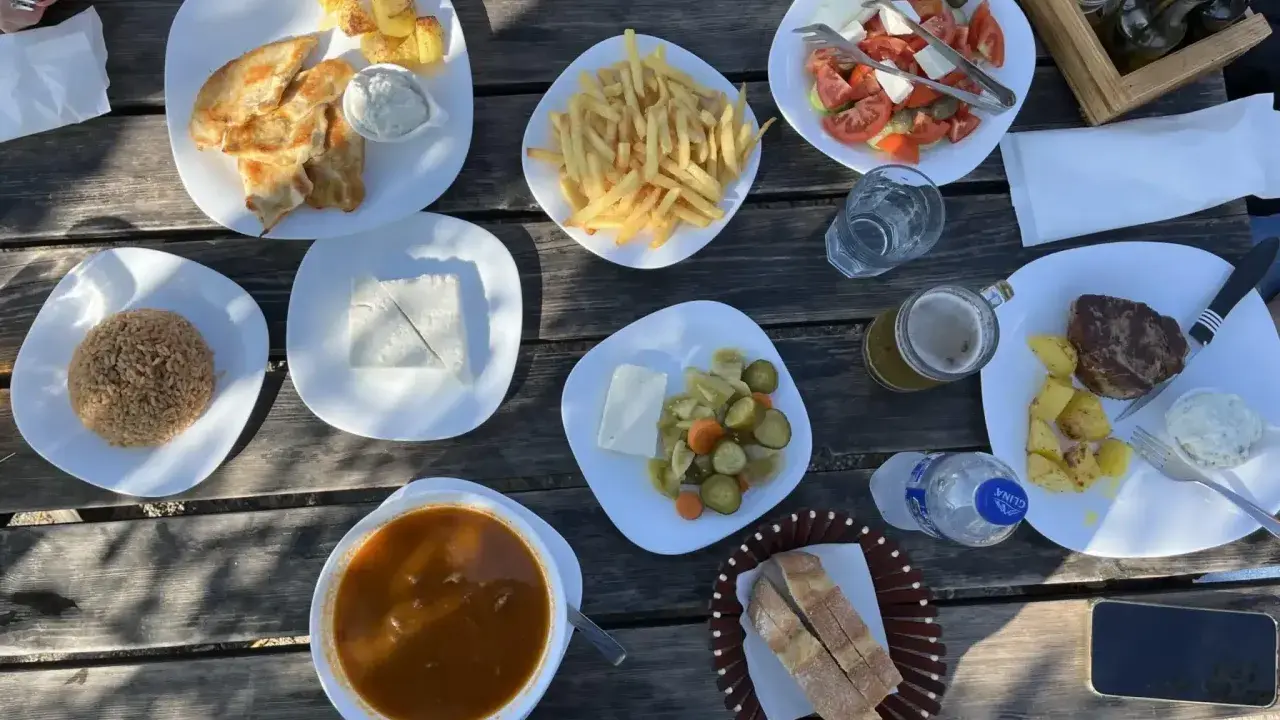 En härlig måltid med albansk mat: kyckling, ris, pommes frites, sallad, kött och bröd.